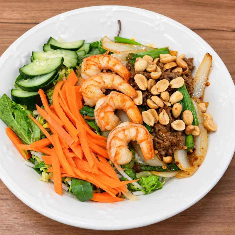 Grilled shrimp vermicelli bowl with peanuts, pickled carrot, cucumber and herbs